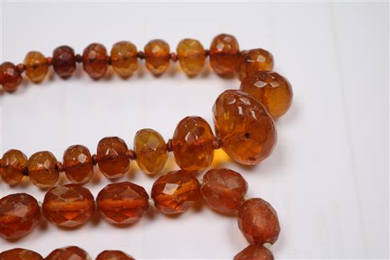 Five assorted amber necklaces.